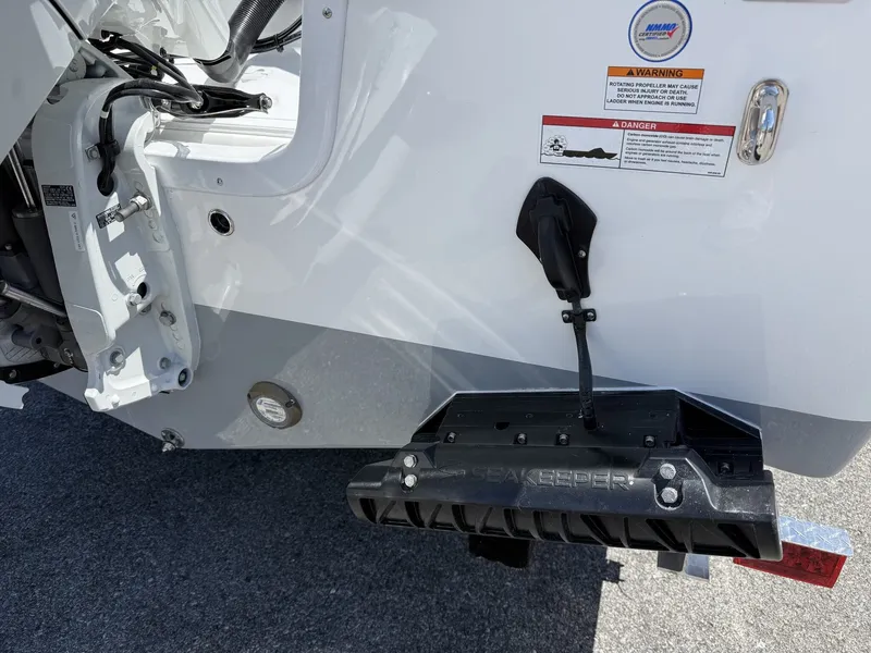 Slide: The Image of Rear view of 2026 Sea Pro 242 DLX with Seakeeper stabilizer. - 6