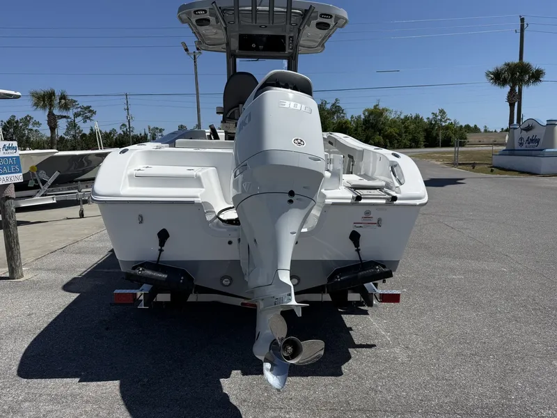 Slide: The Image of Rear view of a 2026 Sea Pro 242 DLX boat in a parking lot. - 7
