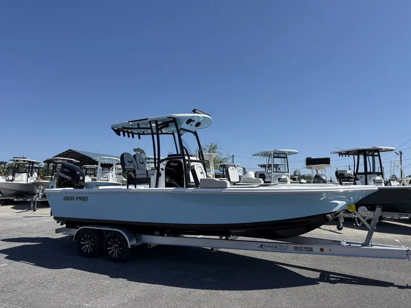 The Image of 2026 Sea Pro 250 Bay boat on trailer under clear blue sky. - 1