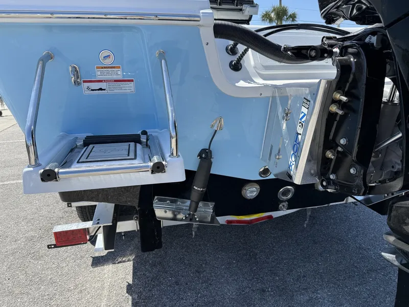 Slide: The Image of Rear view of a 2026 Sea Pro 250 Bay boat with blue finish. - 4