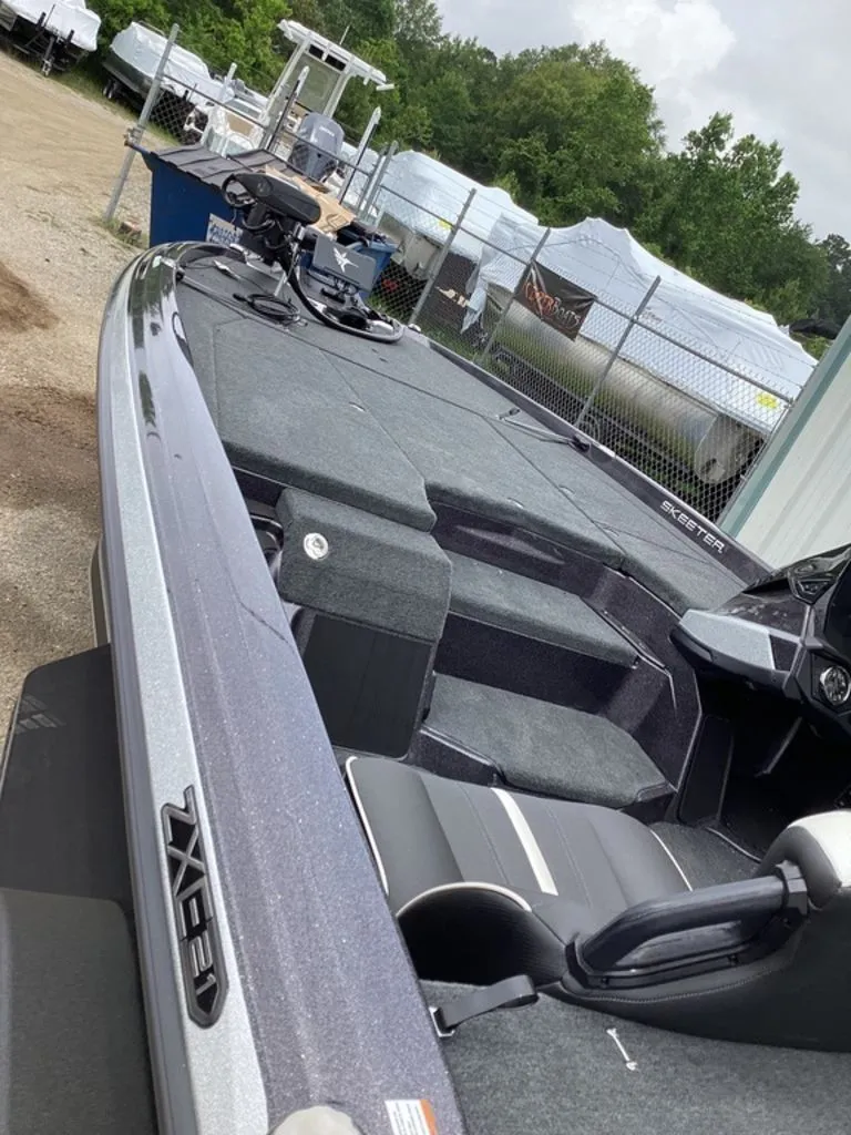 Slide: The Image of Skeeter ZXE21 2026 boat with sleek design parked outdoors. - 12