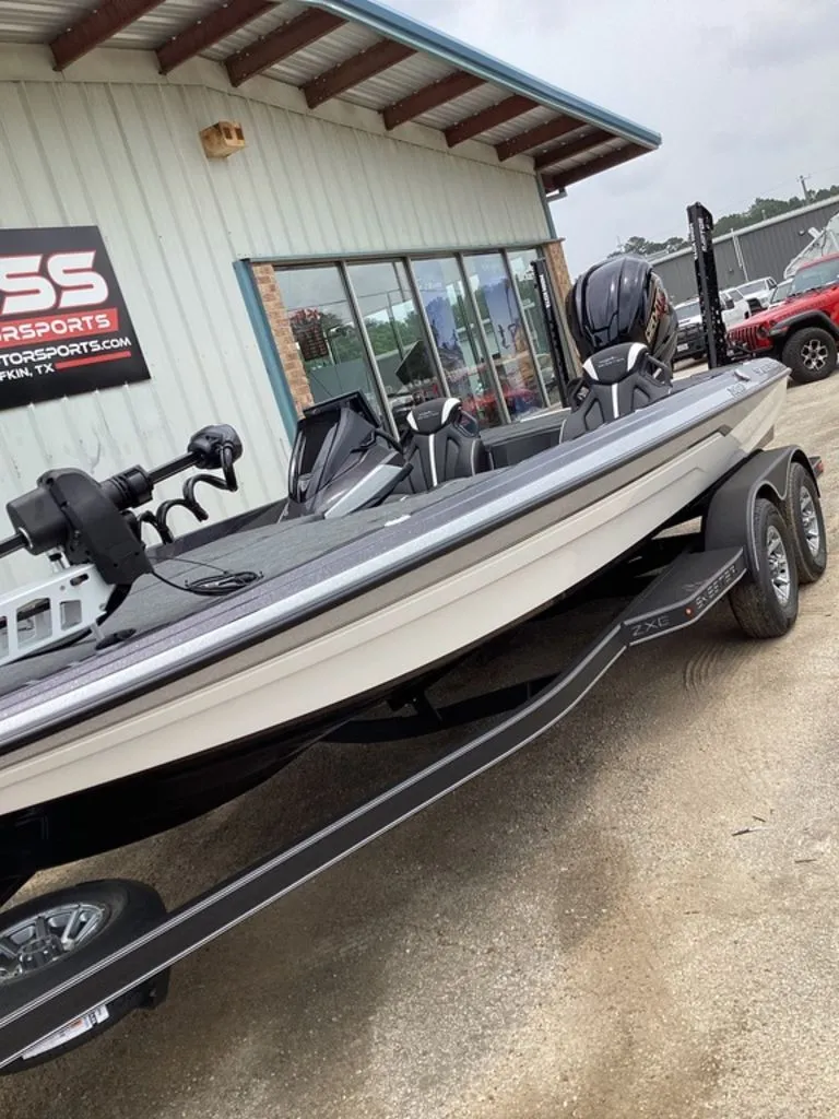 Slide: The Image of 2026 Skeeter ZXE21 boat parked outside a store. - 14