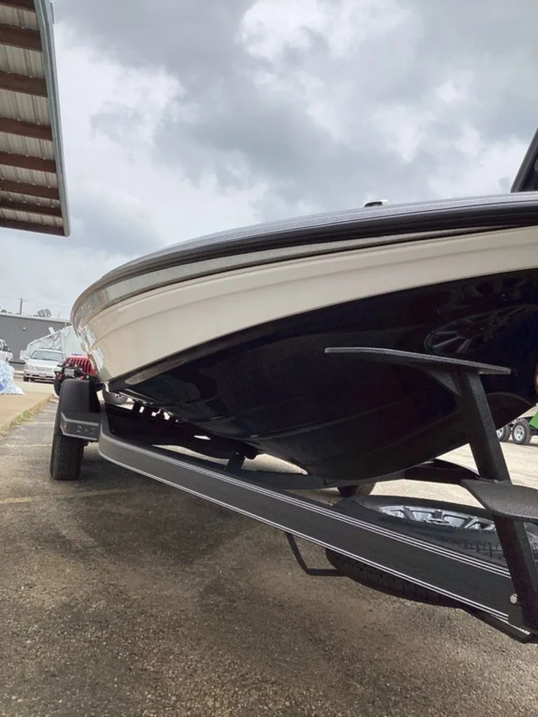 Slide: The Image of 2026 Skeeter ZXE21 boat on trailer under cloudy sky. - 20
