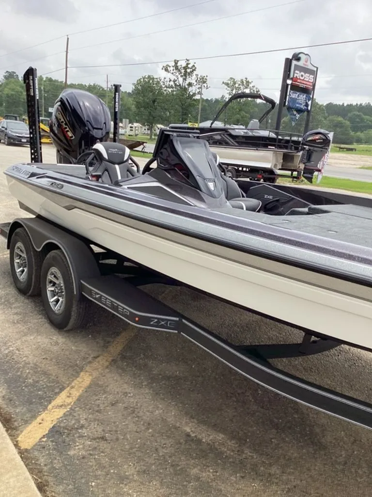 Slide: The Image of 2026 Skeeter ZXE21 boat on trailer, parking lot view. - 22