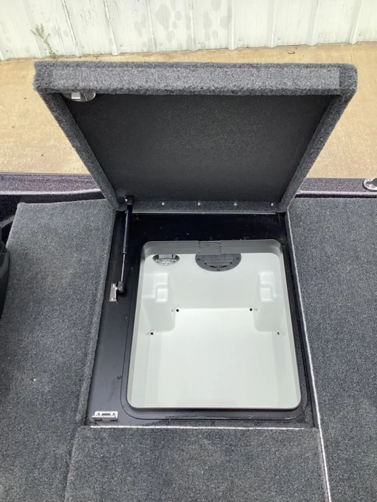 Slide: The Image of Open storage compartment of a 2026 Skeeter ZXE21 boat. - 29