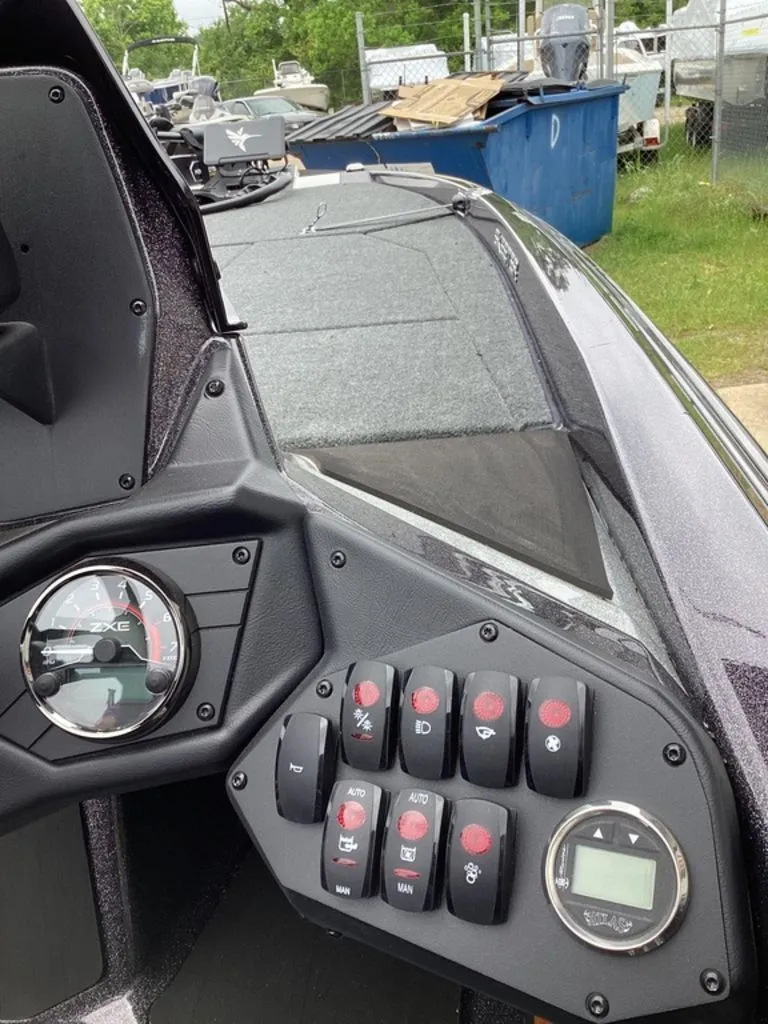 Slide: The Image of Dashboard of a 2026 Skeeter ZXE21 boat with switches and gauges. - 41