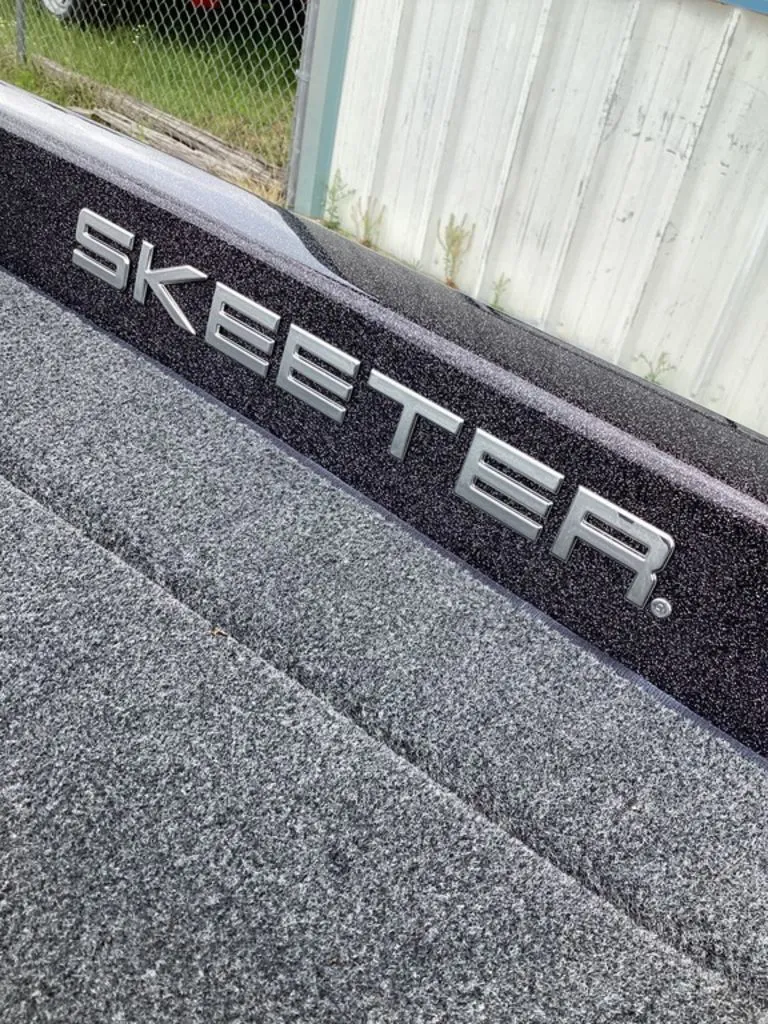 Slide: The Image of Skeeter ZXE21 2026 boat with gray carpeted deck. - 49