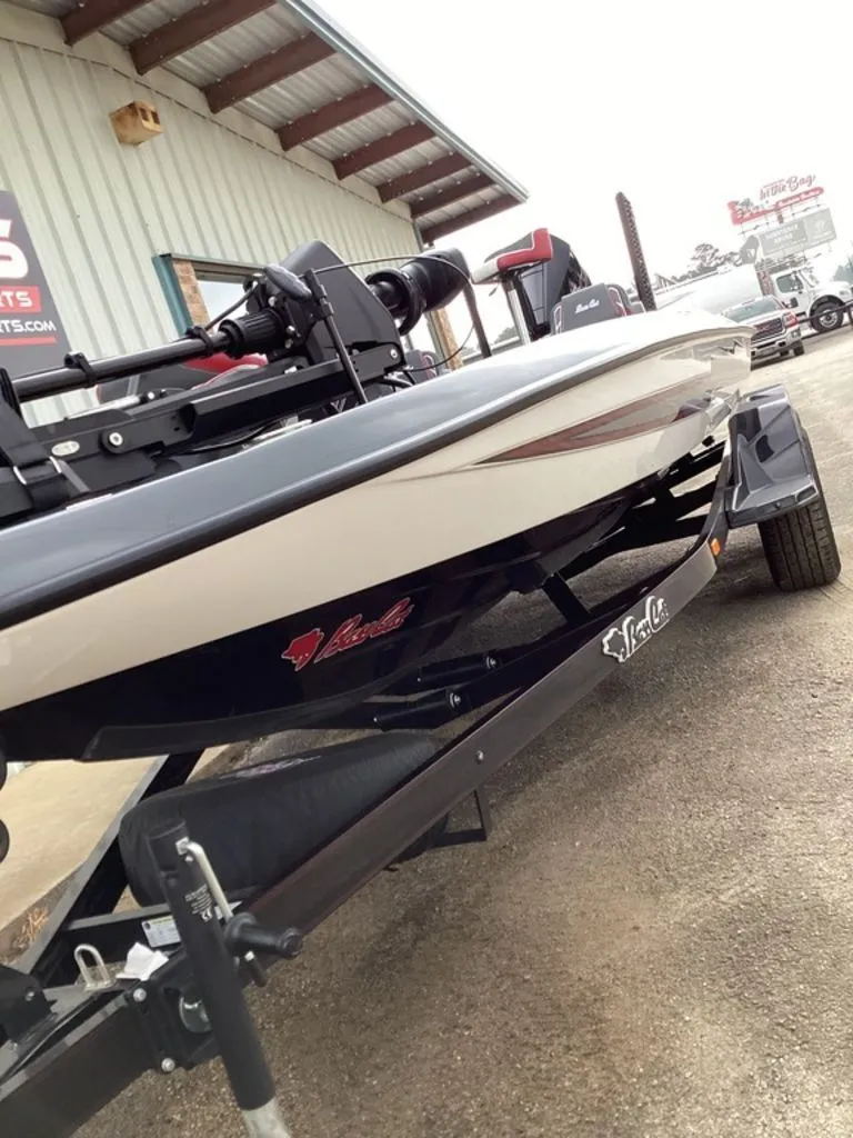 Slide: The Image of 2026 Bass Cat Cougar FTD SP boat on trailer outside building. - 16