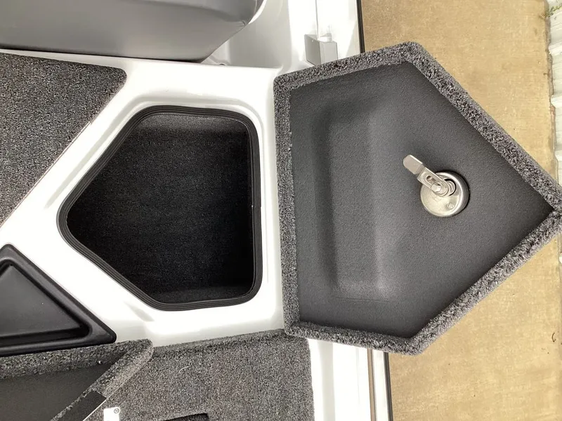Slide: The Image of Bass Cat Cougar FTD SP 2026 storage compartment with carpet and lock. - 27