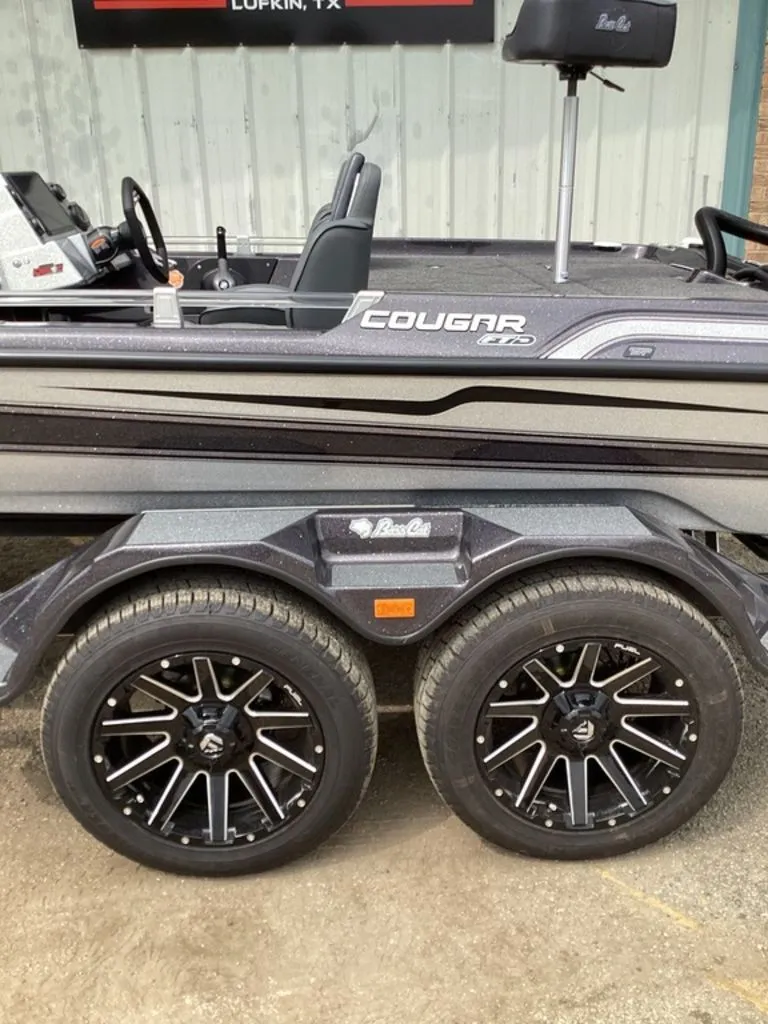 Slide: The Image of 2026 Bass Cat Cougar FTD SP boat with stylish wheels. - 10