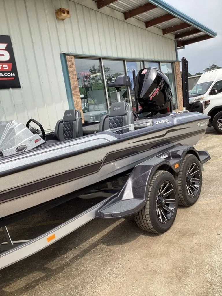 Slide: The Image of 2026 Bass Cat Cougar FTD SP boat parked outside a building. - 15