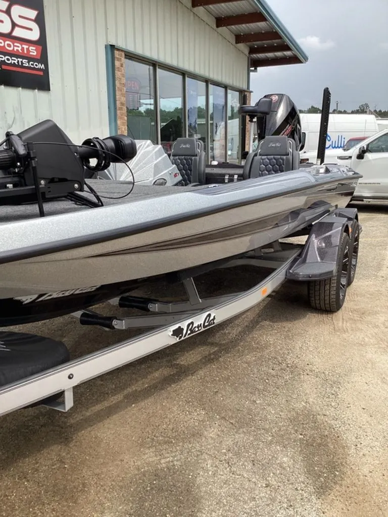Slide: The Image of 2026 Bass Cat Cougar FTD SP boat on trailer outside building. - 16