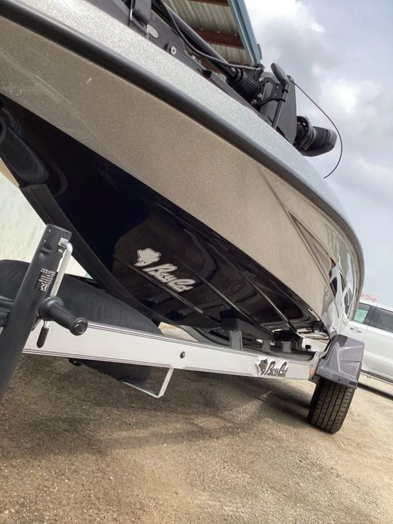 Slide: The Image of 2026 Bass Cat Cougar FTD SP boat on trailer, side view. - 17