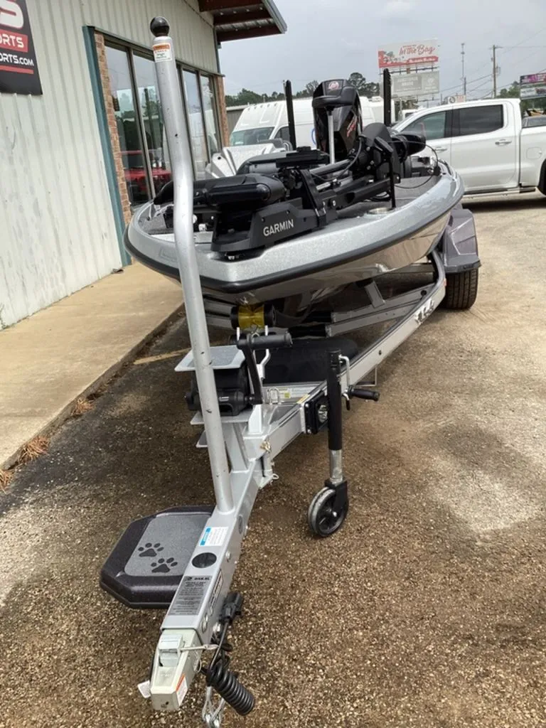 Slide: The Image of 2026 Bass Cat Cougar FTD SP on trailer outside a building. - 18