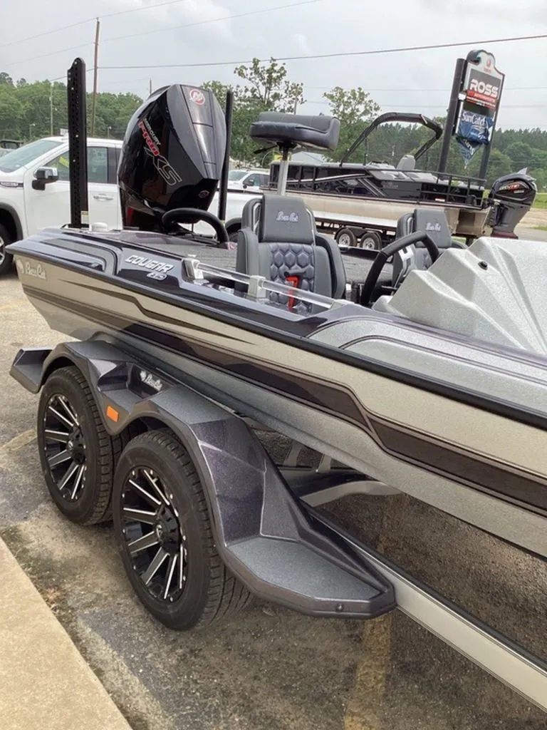 Slide: The Image of 2026 Bass Cat Cougar FTD SP boat on trailer, side view. - 23