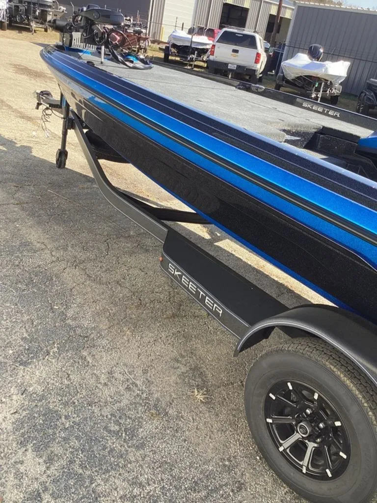 Slide: The Image of 2026 Skeeter ZXE21 boat with blue stripe on trailer. - 16