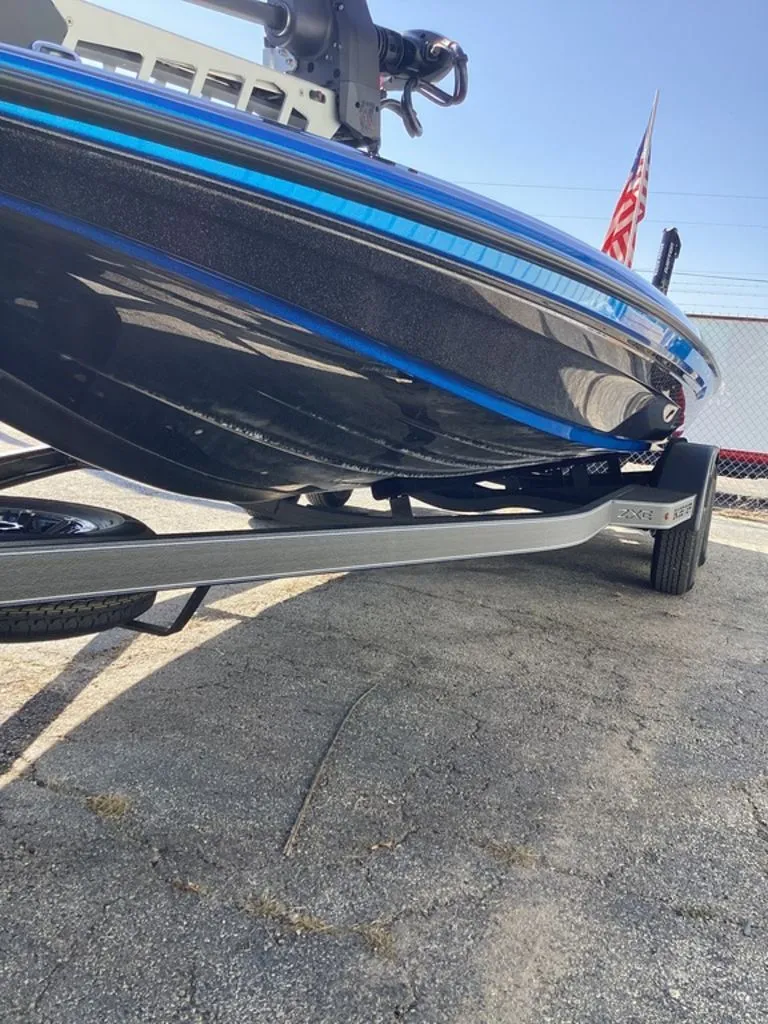 Slide: The Image of 2026 Skeeter ZXE21 boat on trailer, side view with blue stripe. - 17