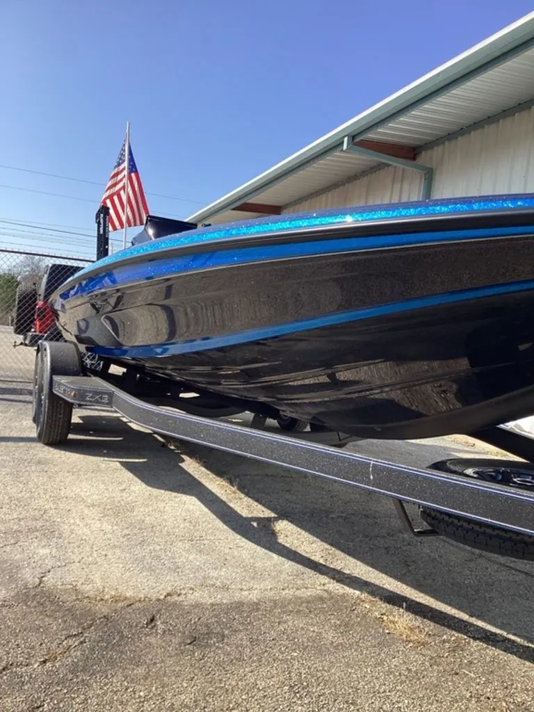 Slide: The Image of 2026 Skeeter ZXE21 boat on trailer with American flag. - 22