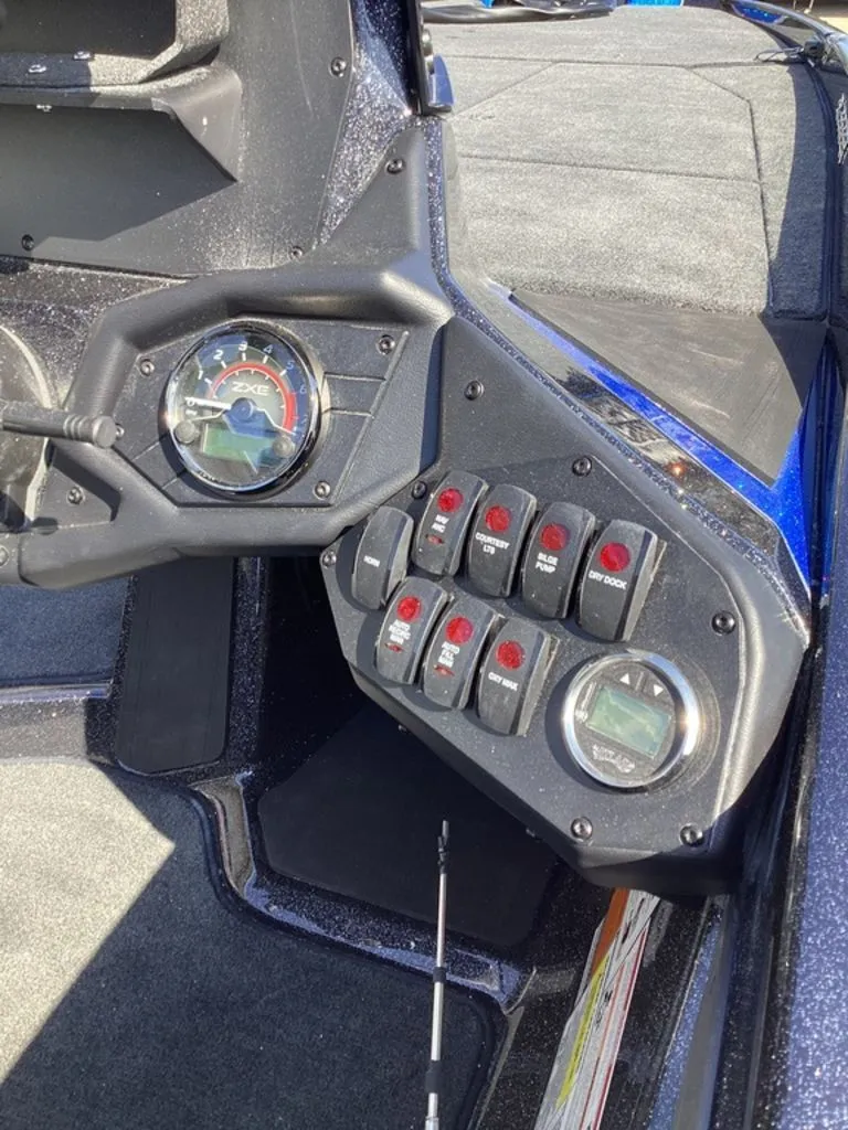 Slide: The Image of Dashboard of a 2026 Skeeter ZXE21 boat with switches and gauges. - 25