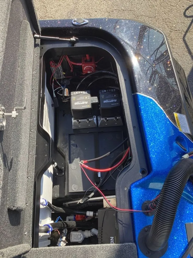 Slide: The Image of Battery compartment of a 2026 Skeeter ZXE21 boat with two batteries. - 26