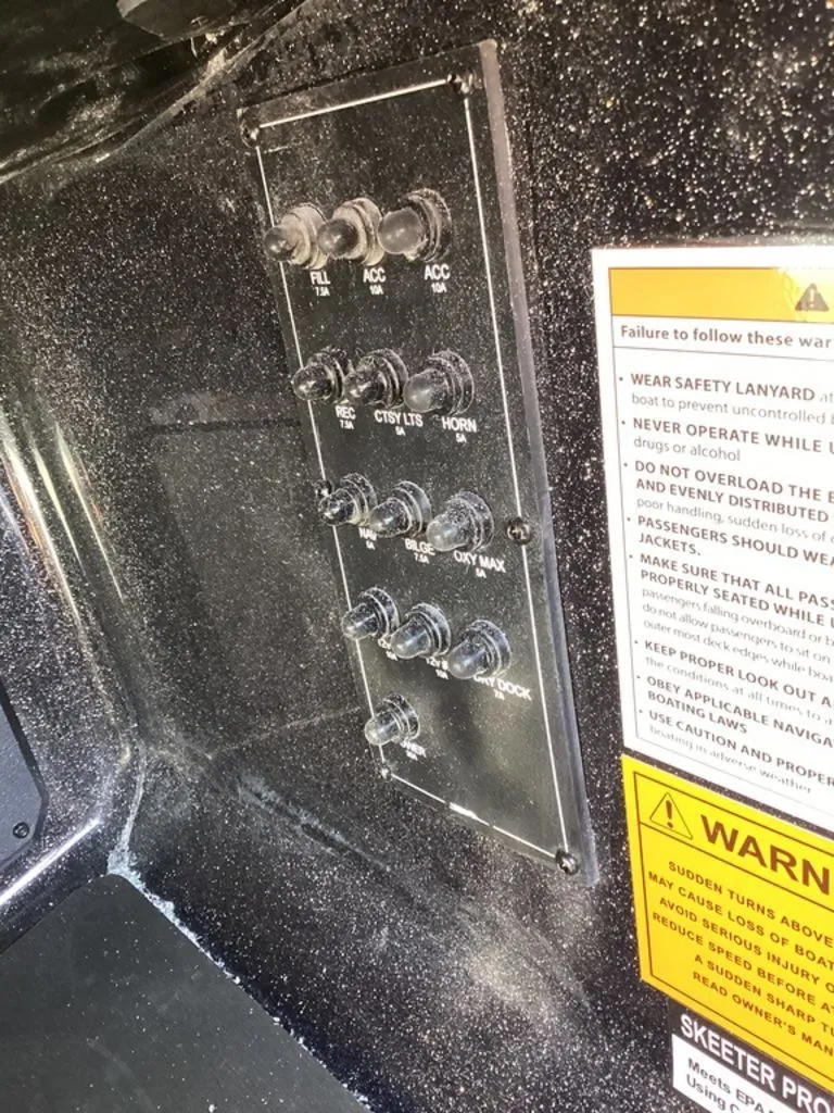 Slide: The Image of Control panel of a 2026 Skeeter ZXE21 boat with warning labels. - 36