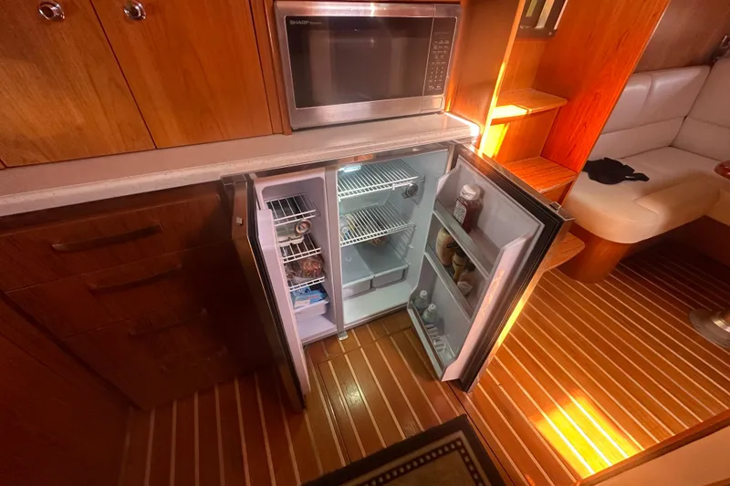 Slide: The Image of Open fridge and microwave in 2011 Tiara Yachts 4300 Open interior kitchen. - 7