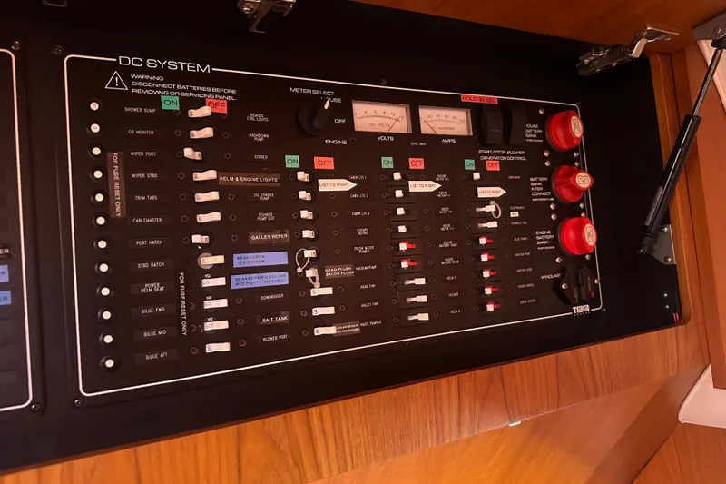 Slide: The Image of Control panel of a 2011 Tiara Yachts 4300 Open, featuring DC system switches and gauges. - 9