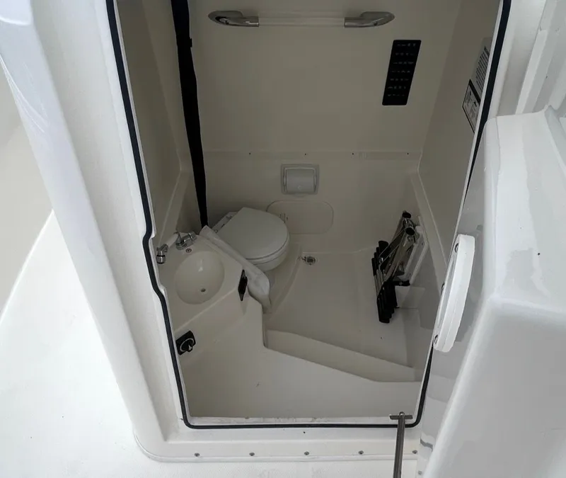Slide: The Image of Interior of 2026 Cobia 245CC featuring toilet and sink. - 10