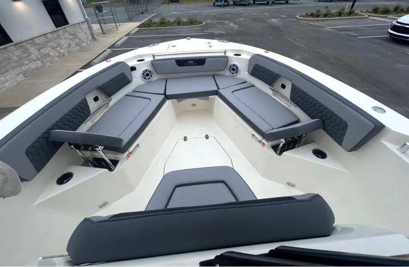 Slide: The Image of Interior view of 2026 Cobia 245CC boat with gray upholstery. - 12