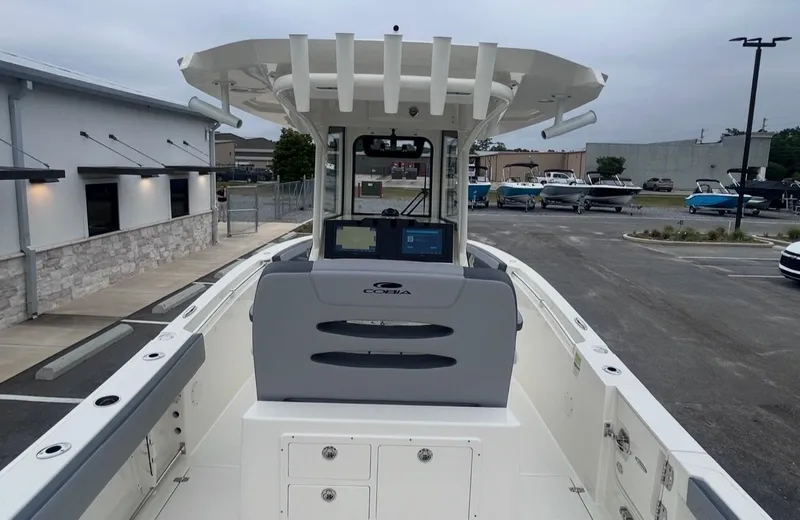 Slide: The Image of 2026 Cobia 245CC boat parked outdoors in lot. - 15