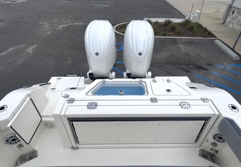 Slide: The Image of Rear view of 2026 Cobia 245CC with dual outboard engines. - 16
