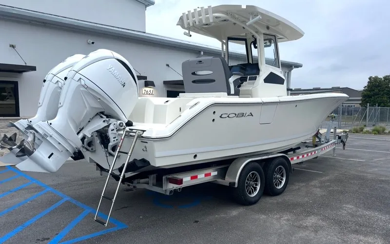 Slide: The Image of 2026 Cobia 245CC boat on trailer with Yamaha engines. - 3