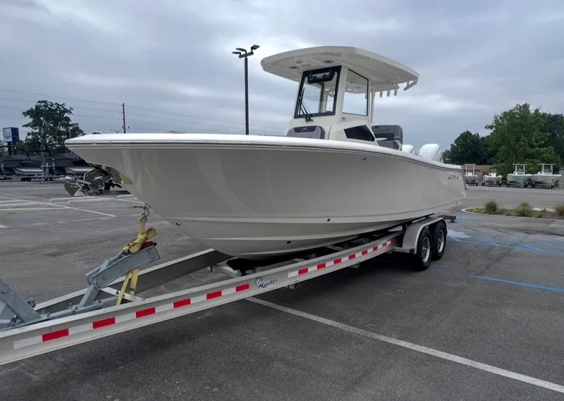 Slide: The Image of 2026 Cobia 245CC boat on trailer parked outdoors. - 5