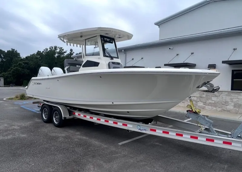 Slide: The Image of 2026 Cobia 245CC boat on trailer in front of building. - 6
