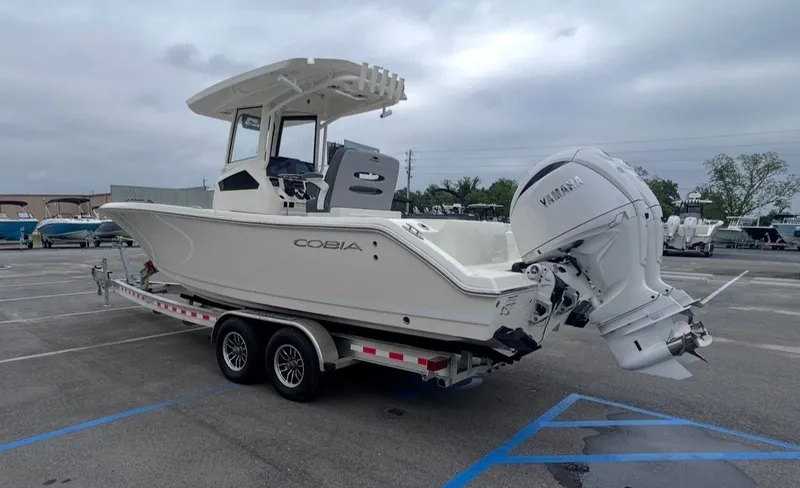 Slide: The Image of 2026 Cobia 245CC boat with Yamaha engine on trailer. - 7