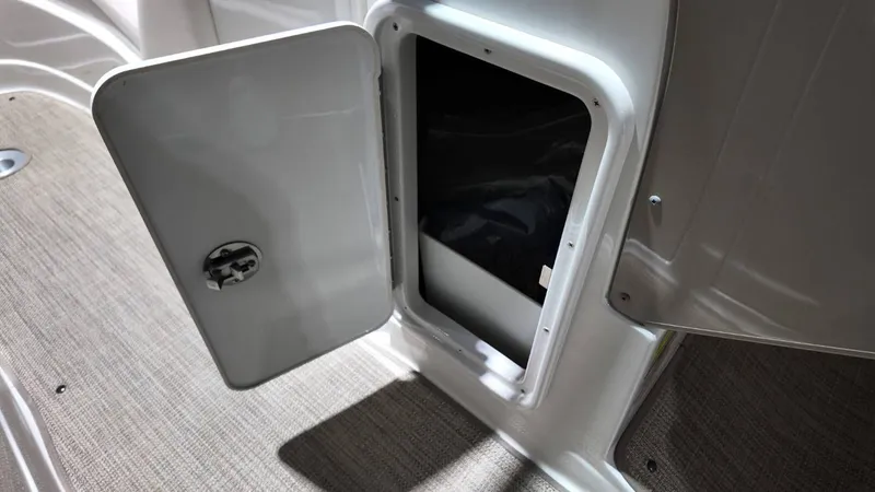 Slide: The Image of Open storage compartment on a 2007 Crownline 240 LS boat. - 16