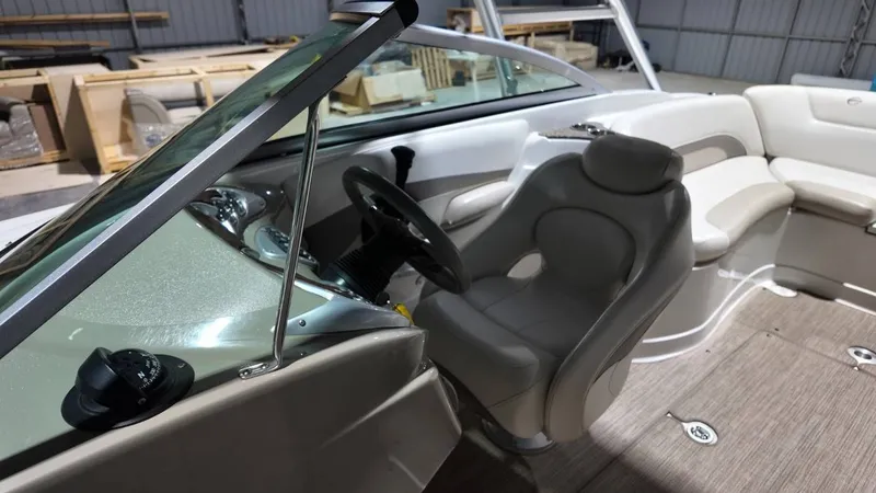 Slide: The Image of Interior of a 2007 Crownline 240 LS boat with steering wheel and seating. - 17