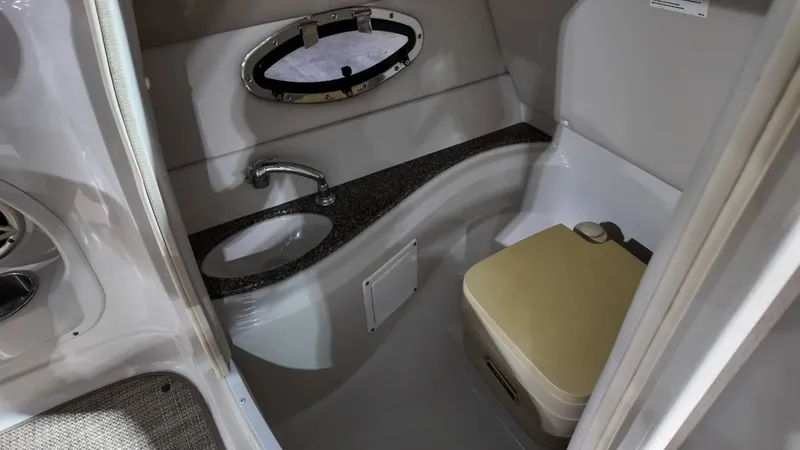 Slide: The Image of Interior of a 2007 Crownline 240 LS with sink and toilet. - 28