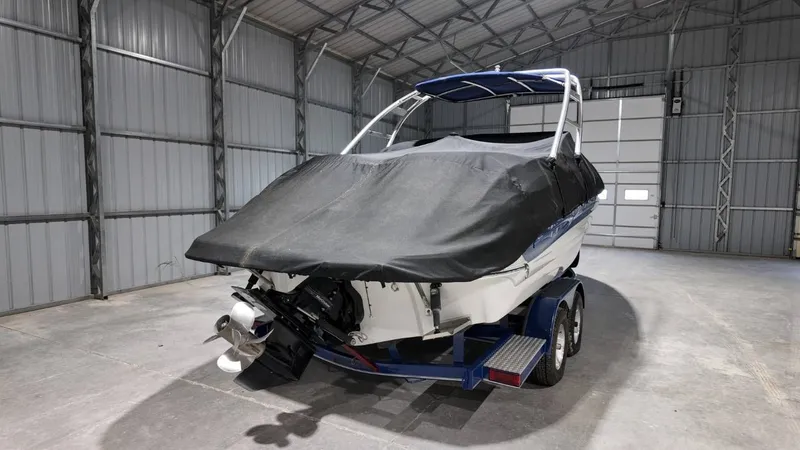 Slide: The Image of 2007 Crownline 240 LS boat with cover in storage facility. - 3