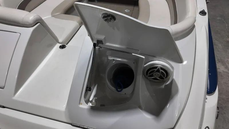 Slide: The Image of 2007 Crownline 240 LS boat with open storage compartment and speaker. - 36