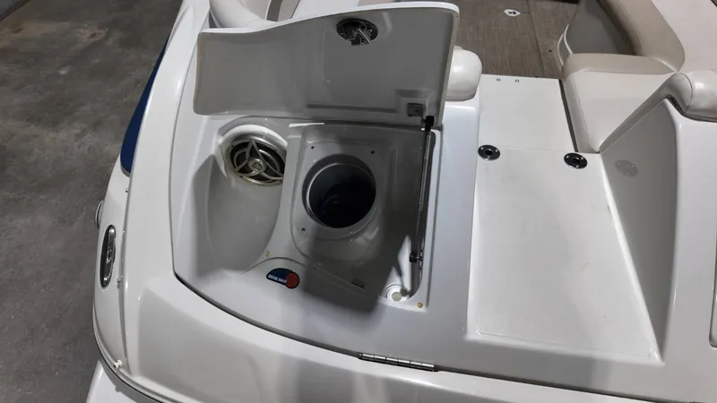 Slide: The Image of 2007 Crownline 240 LS boat with open storage compartment lid. - 37
