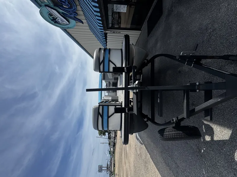 Slide: The Image of Bennington S20 boat on trailer, 2025 model, parked outside a building. - 18
