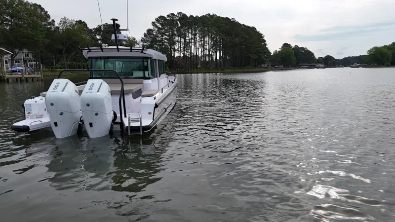 Slide: The Image of Axopar 37 XC Cross Cabin 2025 on a tranquil lake. - 1
