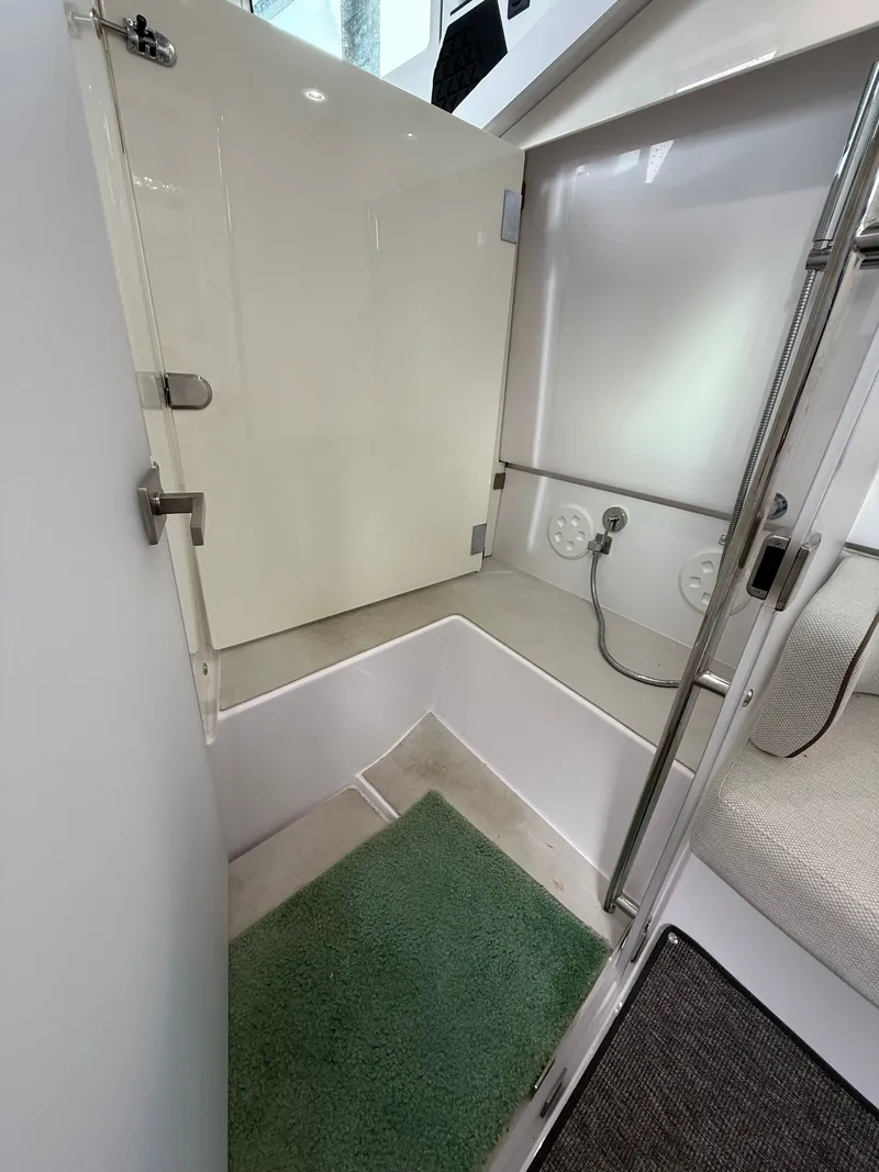 Slide: The Image of Interior of 2025 Axopar 37 XC Cross Cabin with green carpet. - 12
