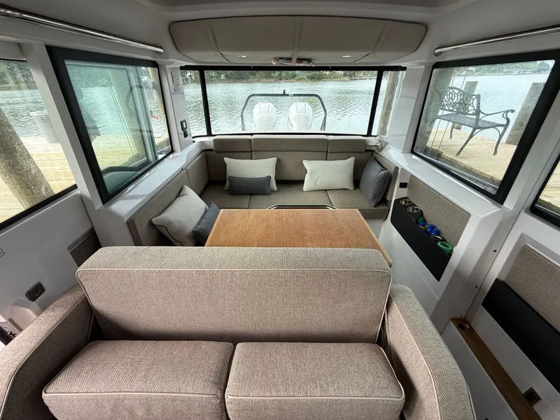 Slide: The Image of Interior of 2025 Axopar 37 XC Cross Cabin with cozy seating area. - 14
