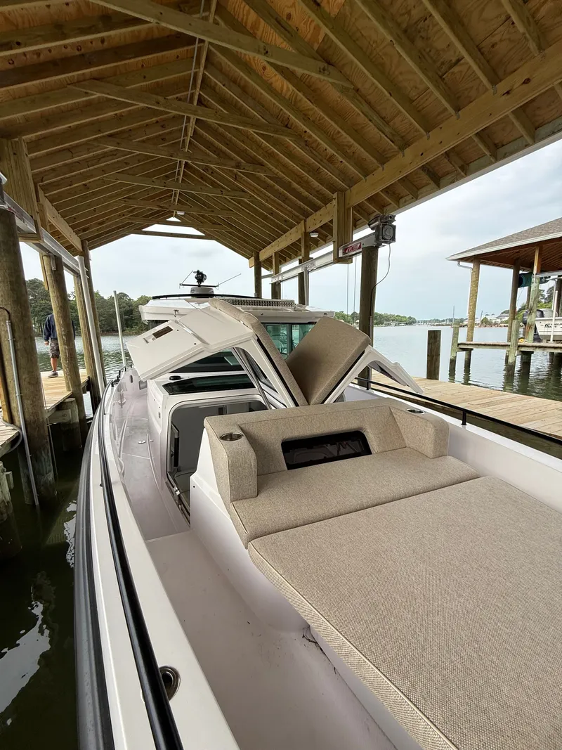 Slide: The Image of Axopar 37 XC Cross Cabin 2025 under covered boat dock. - 15