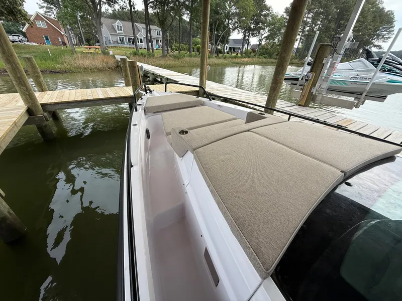 Slide: The Image of Axopar 37 XC Cross Cabin 2025 docked with cushioned seating. - 16