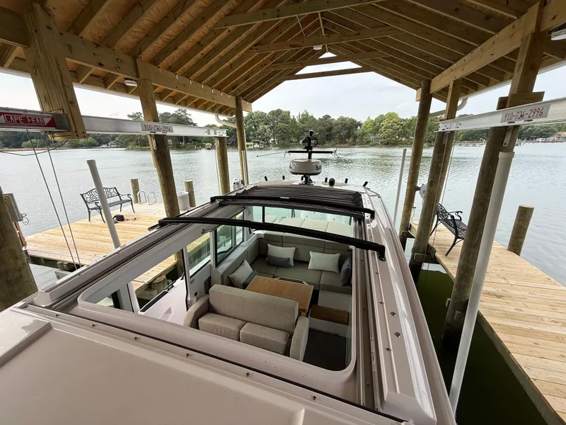 Slide: The Image of Axopar 37 XC Cross Cabin 2025 under covered boathouse. - 17