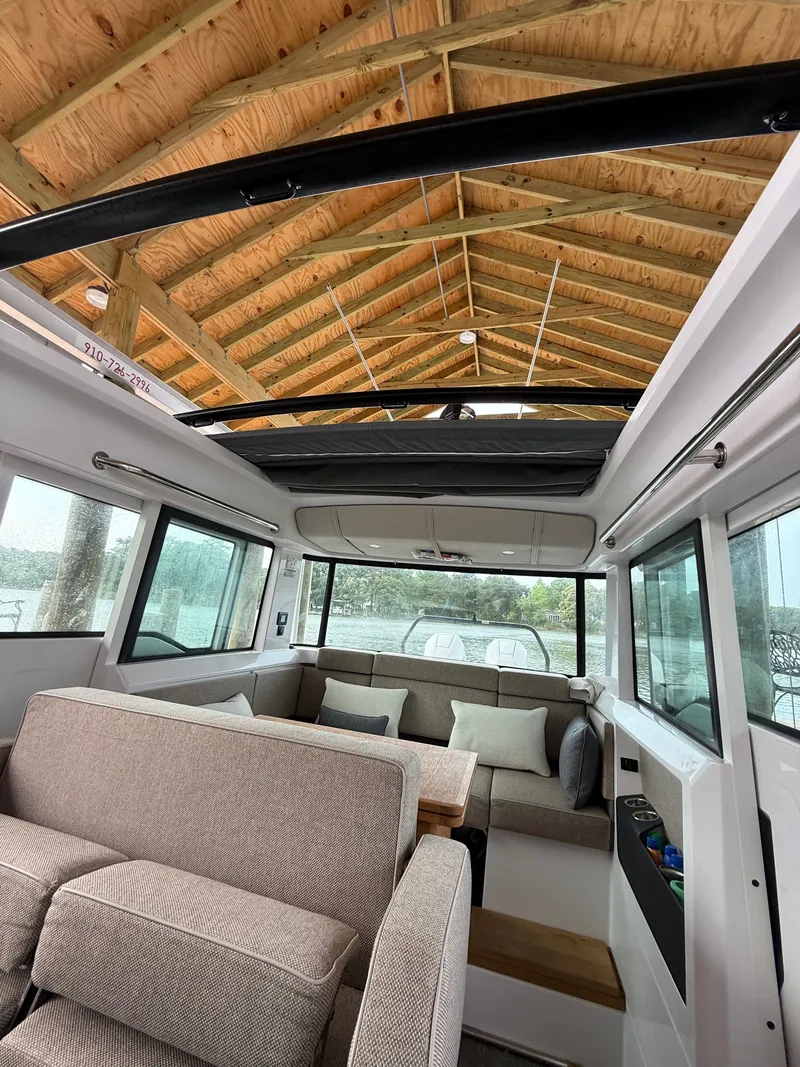 Slide: The Image of Interior of 2025 Axopar 37 XC Cross Cabin with cozy seating area. - 18