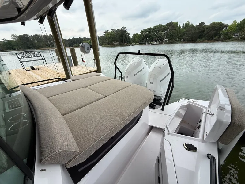 Slide: The Image of Axopar 37 XC Cross Cabin 2025 with Mercury engines by the lake. - 23